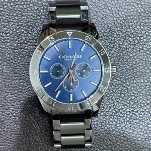 コーチのメンズ腕時計「ケイシーウォッチ42MM」盤面の青はミネラルクリスタルを通してより煌びやかに。
